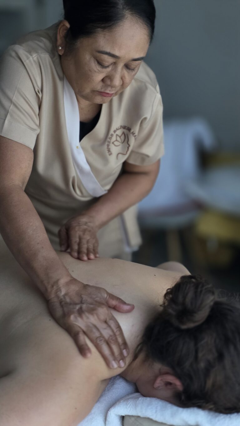 New mother enjoying a calming massage at home in Dubai after giving birth
