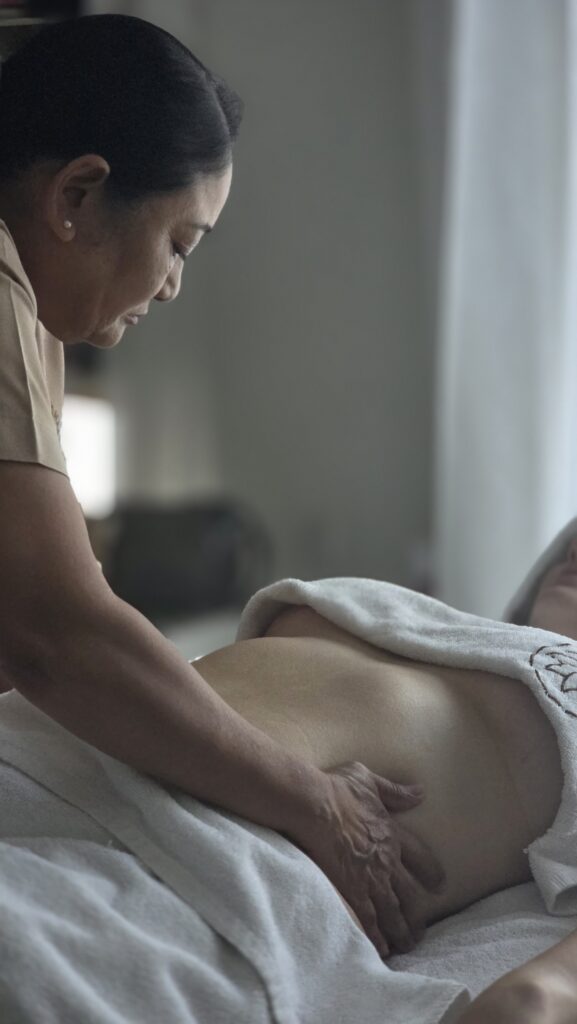 Gentle lymphatic drainage massage on the abdomen after pregnancy