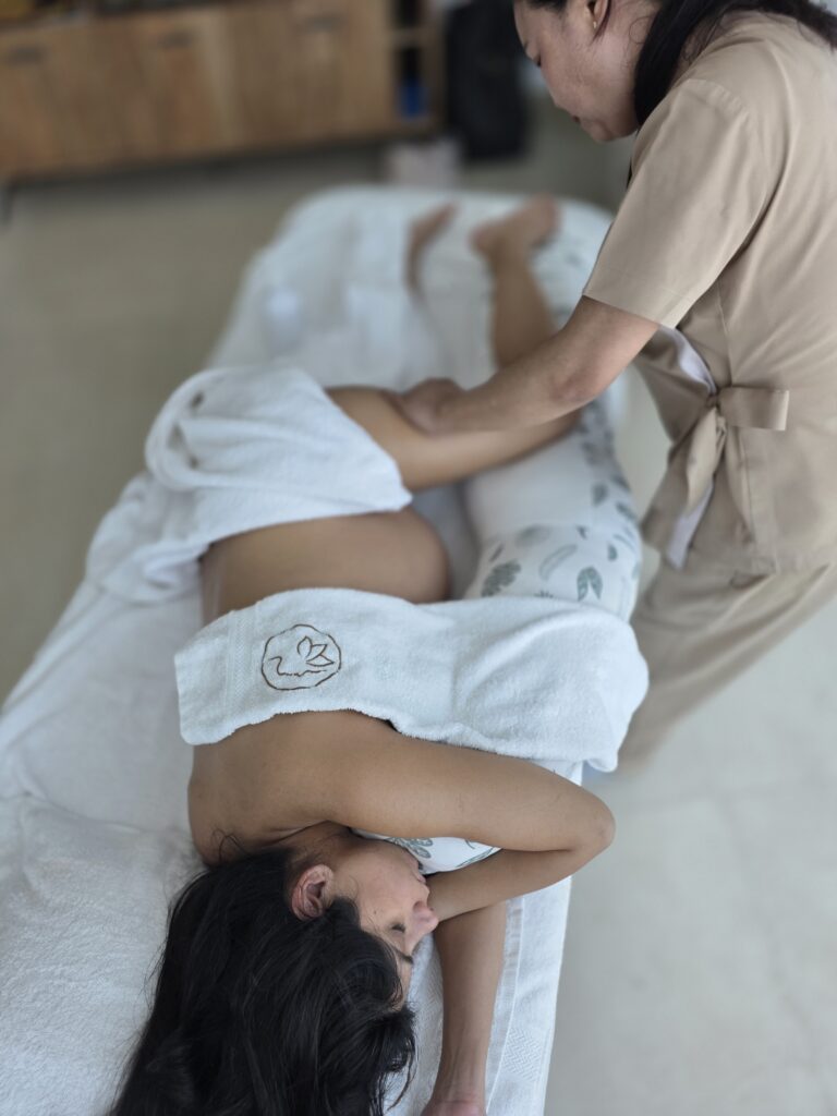 Pregnant client lying comfortably during a prenatal massage at home