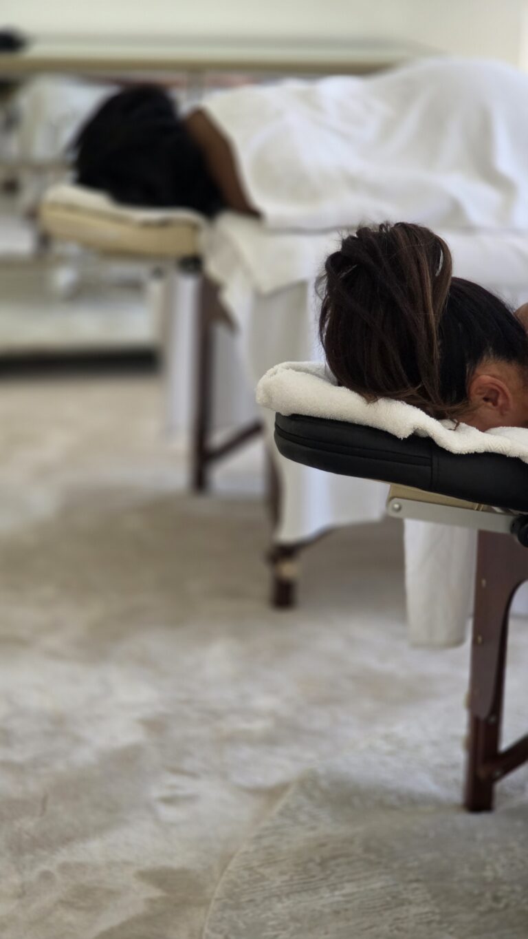 Two Empress therapists massaging side by side at home in Dubai