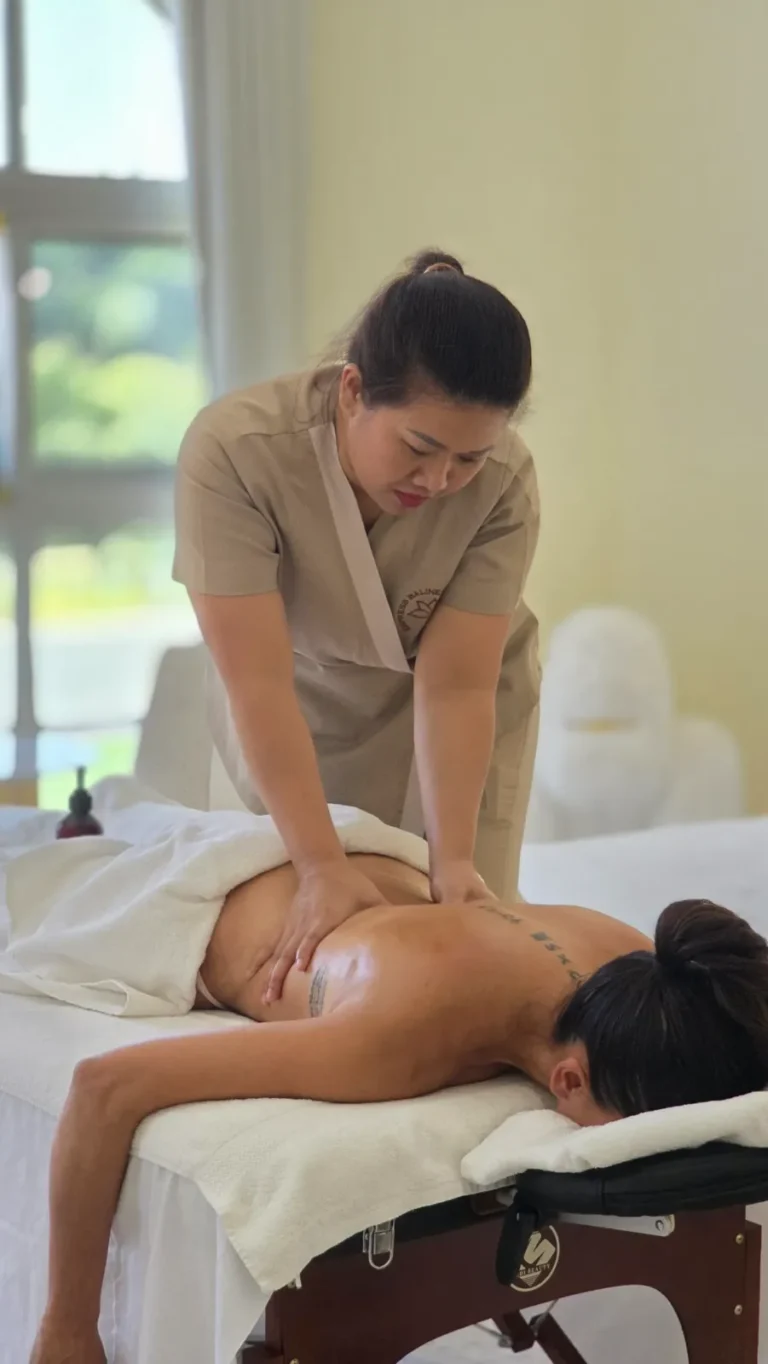 Senior Empress therapist giving a deep tissue massage at home in Dubai