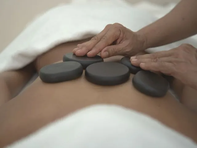 Hot stone massage with warm volcanic stones at home in Dubai