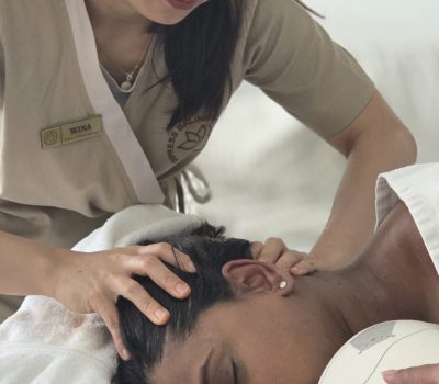 south asian woman having a side lying head massage to relief tensions